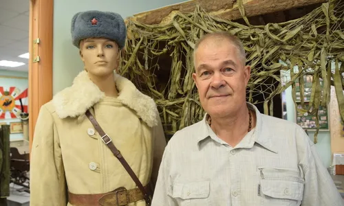 Алексей Сотников на фоне памятника, посвященного Курской битве, обсуждает поисковые работы с членами отряда.